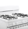 Hotpoint white gas range angled cooktop view highlighting four sealed burners, heavy steel grates and rotary control knobs.