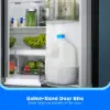 Midea MRF18B4AST refrigerator close-up showing gallon-sized door bins holding a large milk container and other beverages.