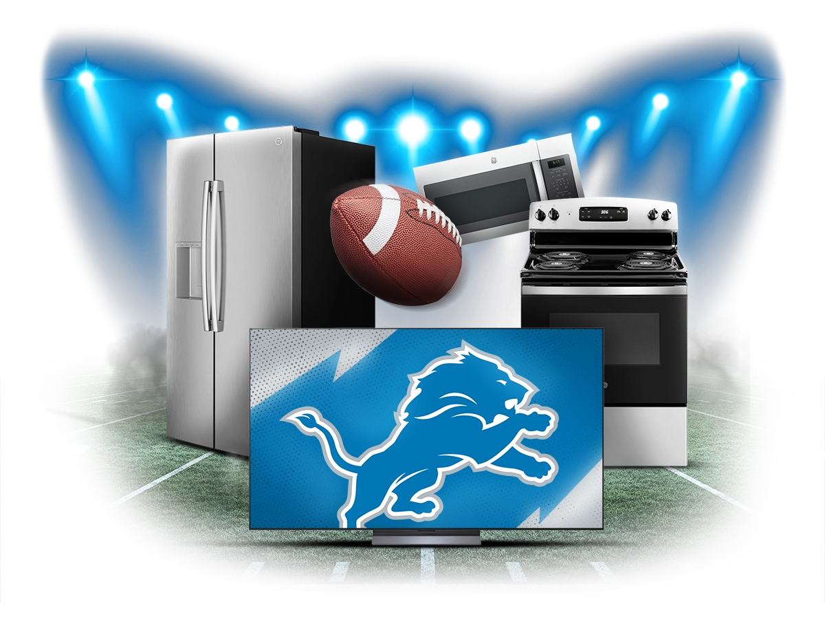 Refrigerator, range, microwave and a big screen TV showing the Detroit Lions logo under stadium lights