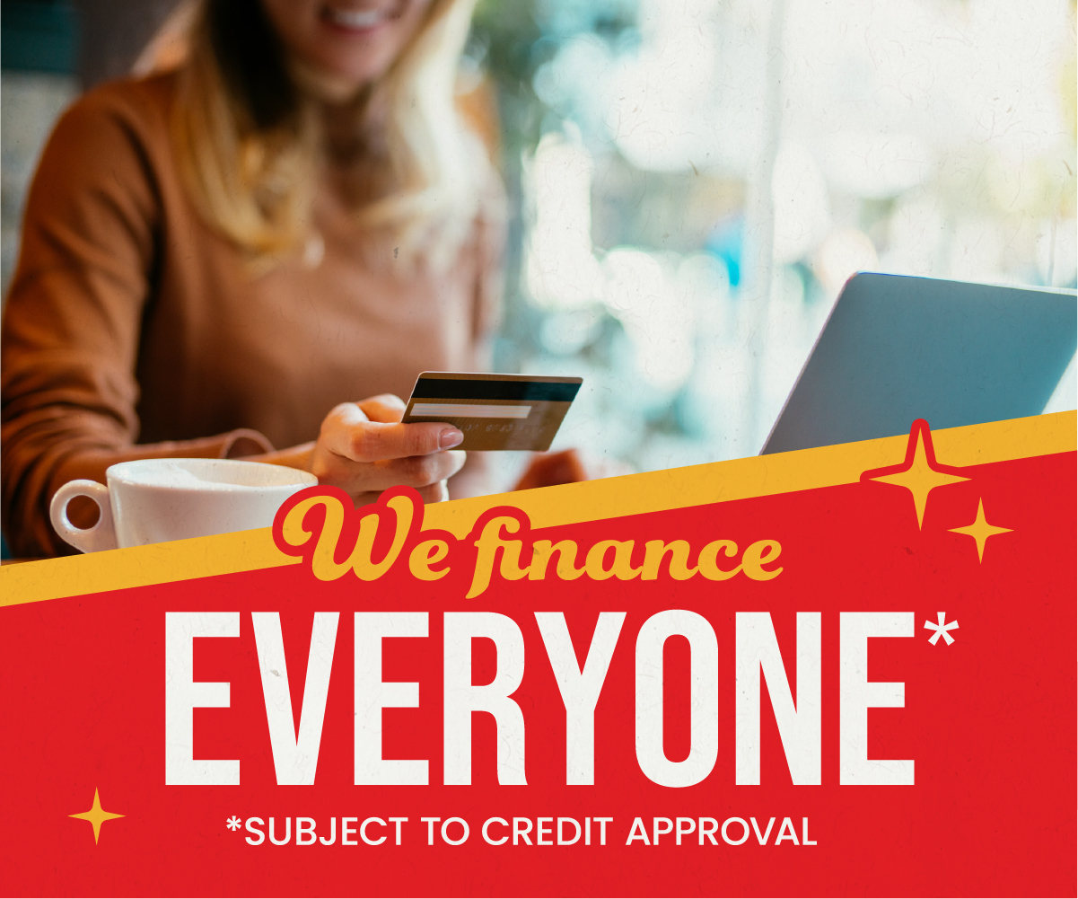 ABC Warehouse financing promotion showing a person holding a credit card next to text that reads “We finance EVERYONE*” with “*Subject to credit approval.”
