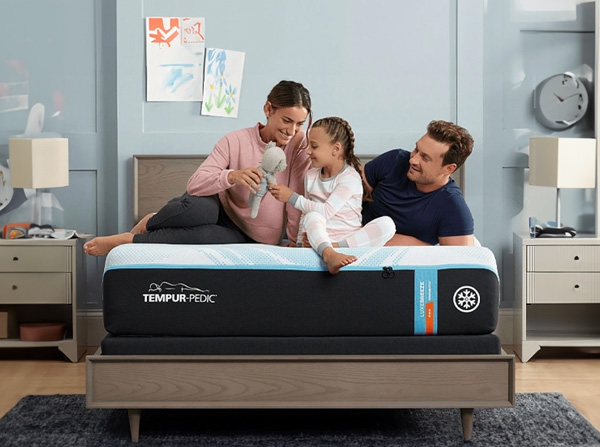 Stack of assorted mattresses with pillows in front, featuring different styles and thicknesses on a clean background with decorative accents.