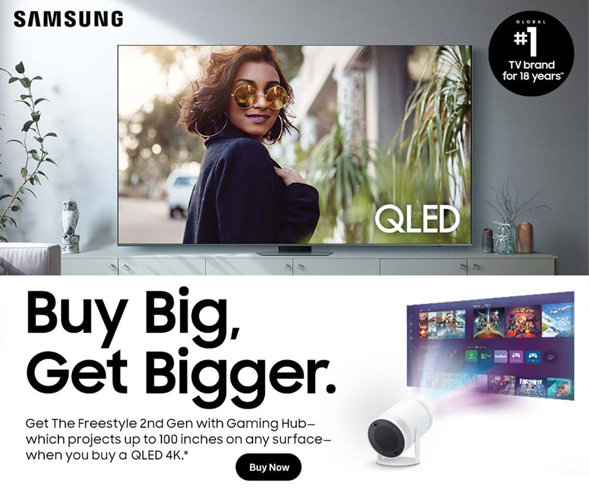 Samsung QLED TV promotion banner showing a living room setup with a QLED display, “Buy Big, Get Bigger” offer, and The Freestyle 2nd Gen projector projecting a gaming interface.